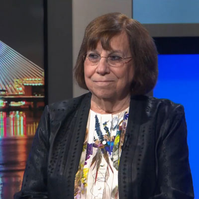 Carol Saivetz sitting in the GBH news room