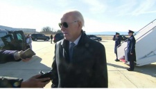 Biden speaks to press in front of a plane