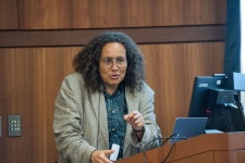 Neta Crawford speaking at a podium at UofL