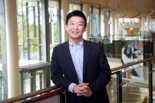 James Kim posing by inside balcony